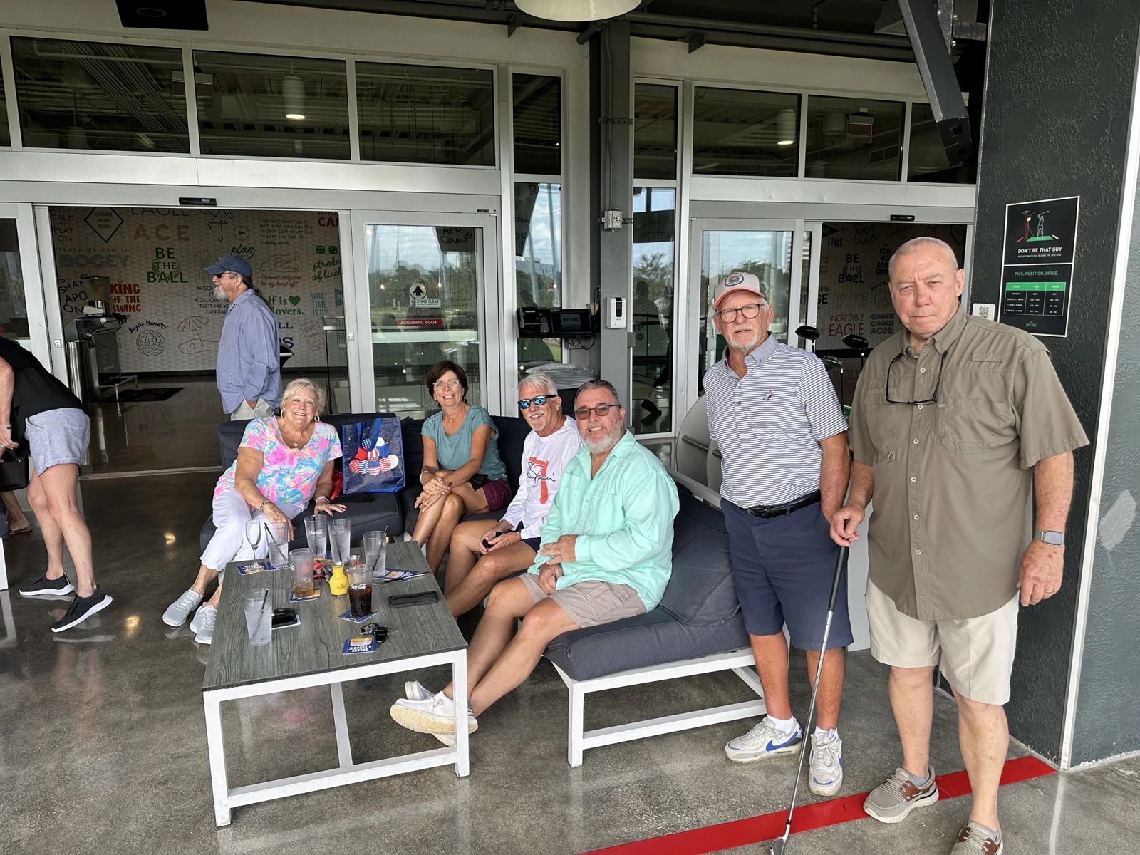 Supporters gathered on lounge seating at the Drive Shack fundraiser