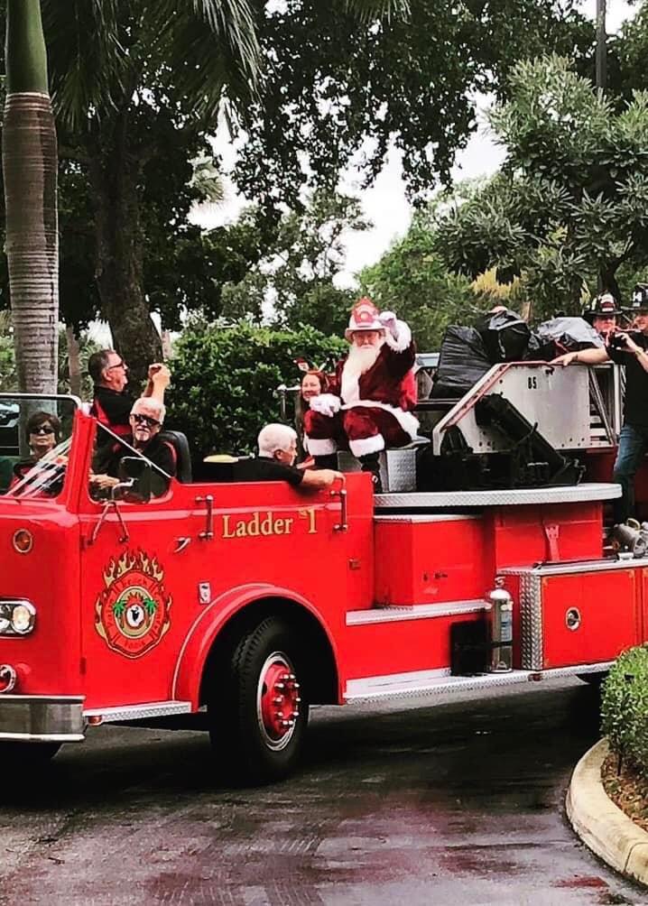 Frank Turner dressed as Santa Claus aboard the historic 1961 ladder truck