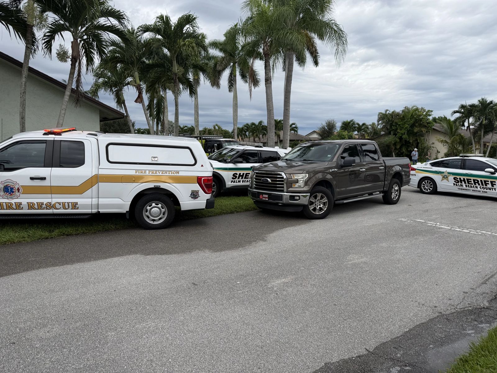 Greenacres Fire Rescue Fire Prevention and Palm Beach County Sheriff's Office vehicles parked on a residential street during an incident